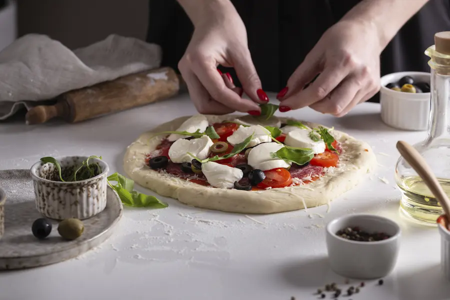 Demonstration of how to add toppings to pizza